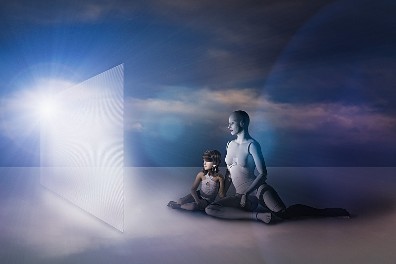 白人女性機器人和女孩坐在地板上看虛擬屏幕圖片素材
