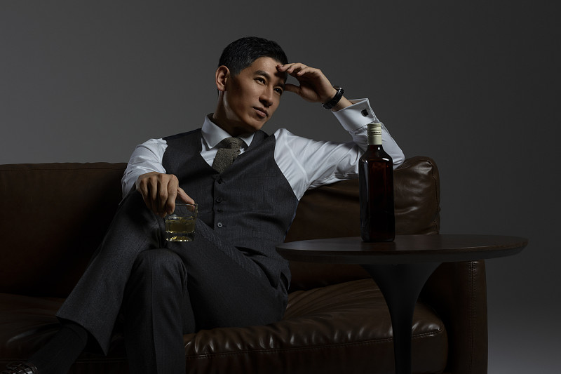 成熟商务男士喝威士忌酒肖像特写图片下载