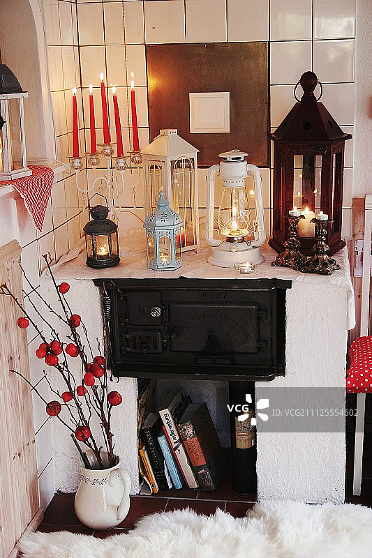 烛台上的红色蜡烛和砖石炉上的老式灯笼图片素材