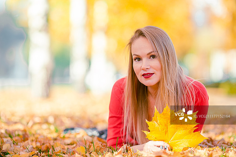 秋天概念-美丽的女人在秋天的树叶下喝咖啡秋天公园图片素材