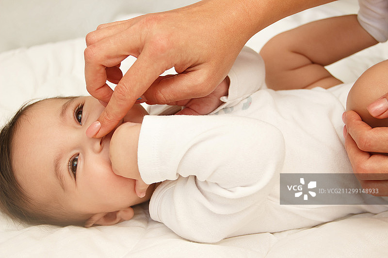 婴儿和母亲的手，室内，软焦点背景图片素材