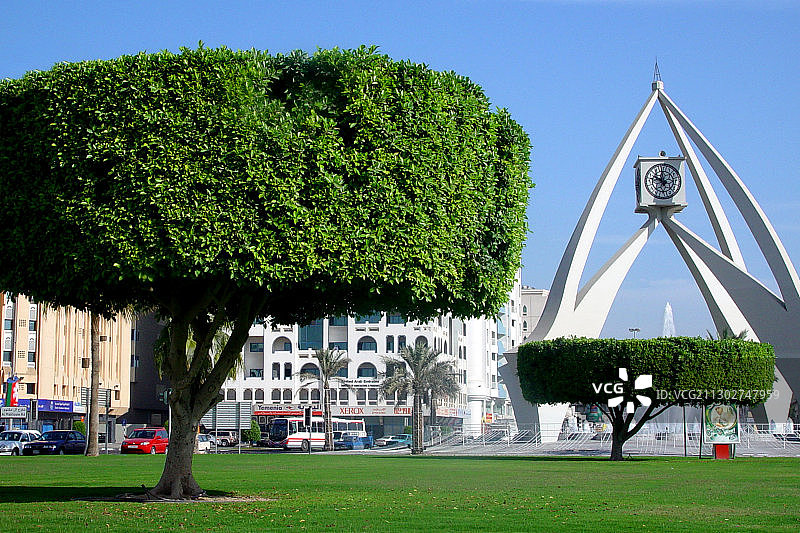 阳光下的树和钟楼，迪拜，阿联酋，阿拉伯联合酋长国，中东，亚洲图片素材