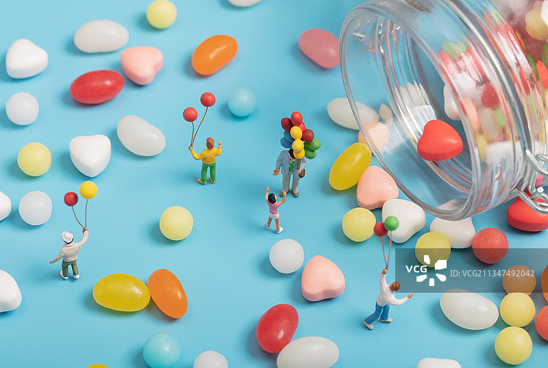 微缩创意打翻的糖果罐里拿着气球的儿童图片素材