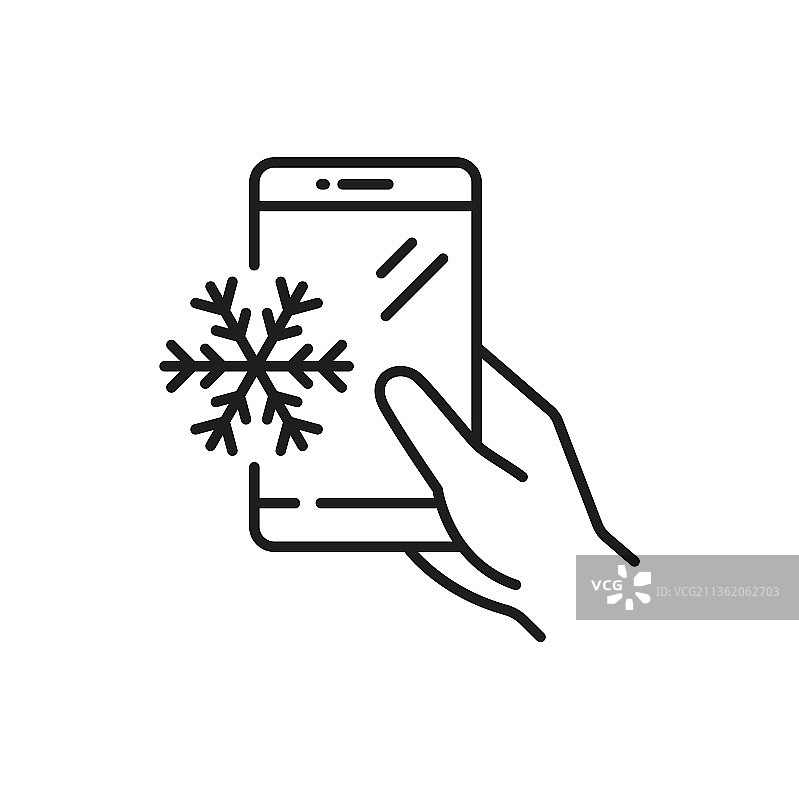 手里拿着智能手机屏幕上的雪花轮廓图片素材