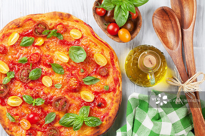 披萨配番茄，马苏里拉奶酪和罗勒，披萨正上方的披萨和披萨放在桌子上图片素材