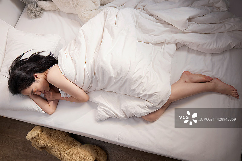 青年女人躺在床上睡觉图片素材