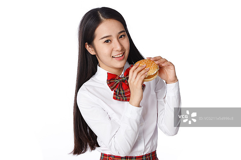 青春活力的青年女学生吃汉堡包图片素材