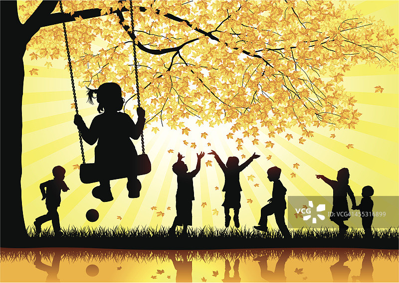 快乐的孩子们在树叶中玩耍。图片素材