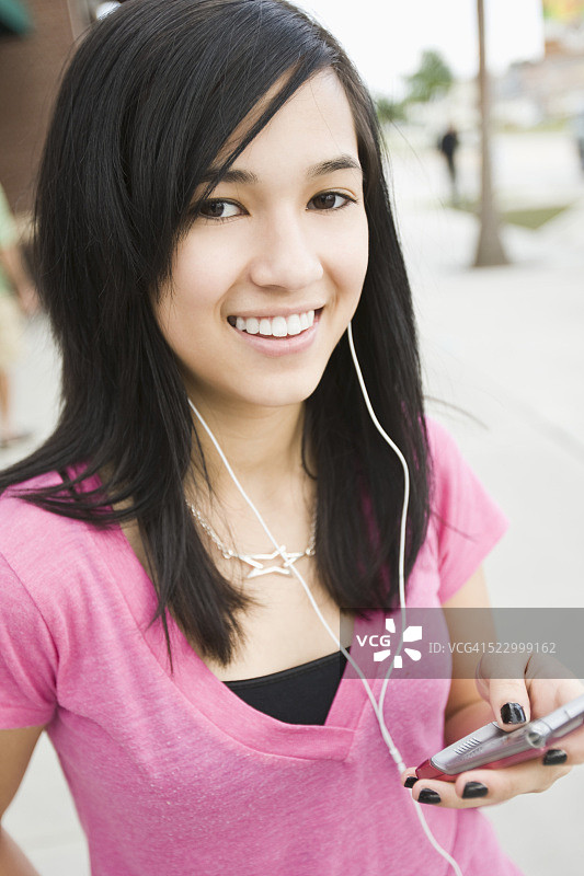 女孩清单到MP3播放器图片素材