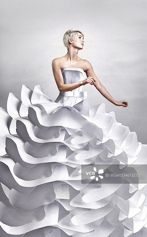 漂亮的女士在长长的白色纸工艺优雅的裙子图片素材