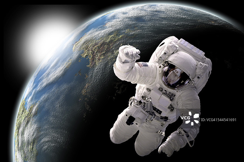 宇航员在外太空漂浮，在类地行星上可以看到日出。图片素材