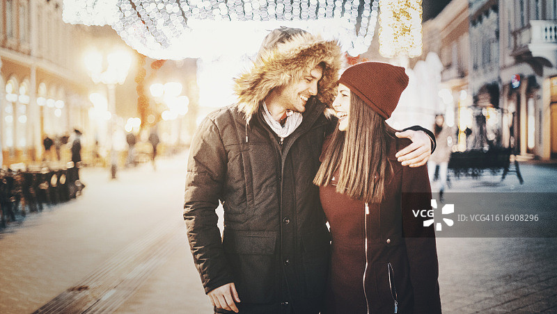 一对情侣在冬夜浪漫散步。图片素材