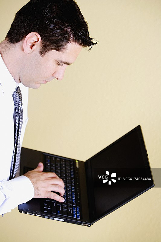 一个商人用笔记本电脑的侧面图图片素材