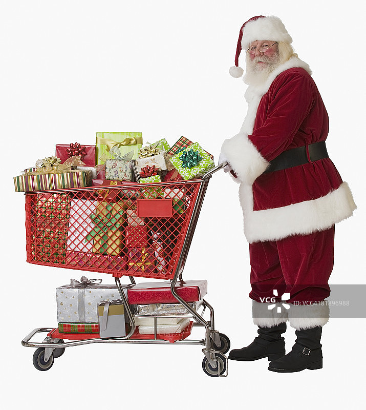 圣诞老人推着装满礼物的购物车图片素材