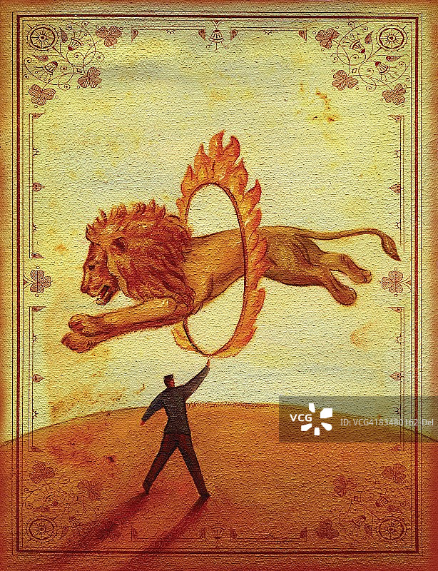 侧面的狮子跳过火圈被一个人抱着图片素材