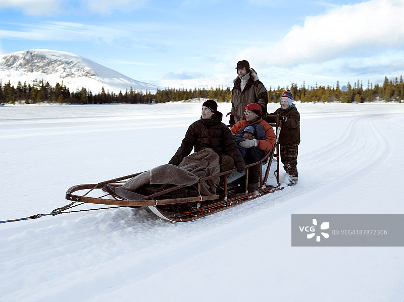 一家人坐在雪橇上图片素材