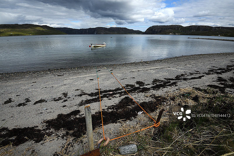 挪威北部Bugøyfjord海滩上的一只小船图片素材