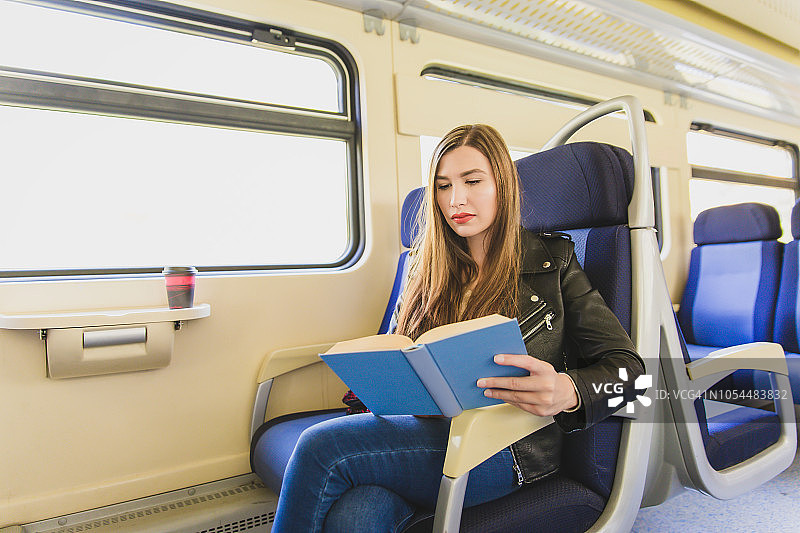 坐火车旅行，读一本书。图片素材