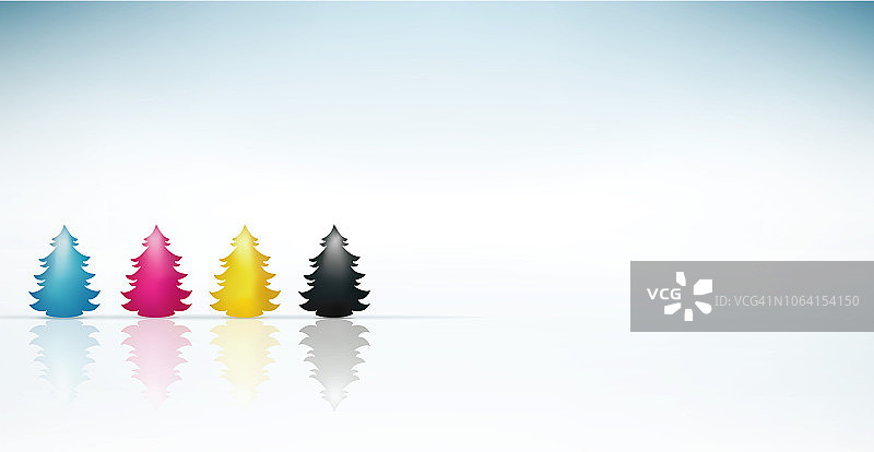 概念cmyk圣诞树青色，品红，黄色，黑色。圣诞快乐。蓝色背景图片素材