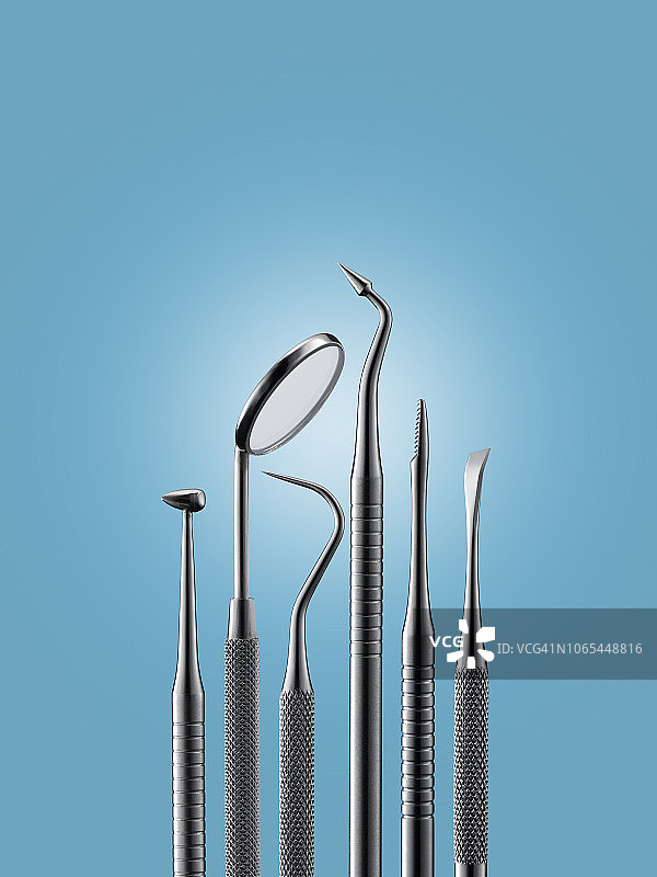 蓝色背景上的牙科工具。图片素材