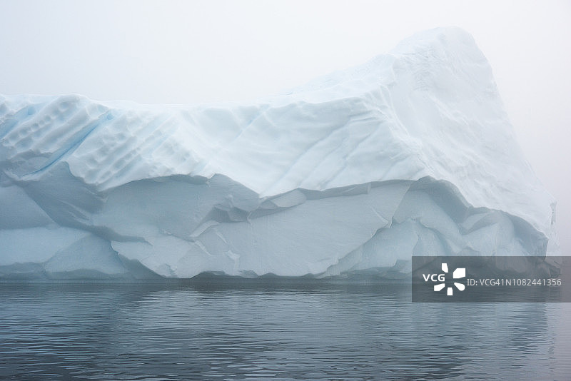 在一个有雾的日子里，北冰洋上的冰山图片素材