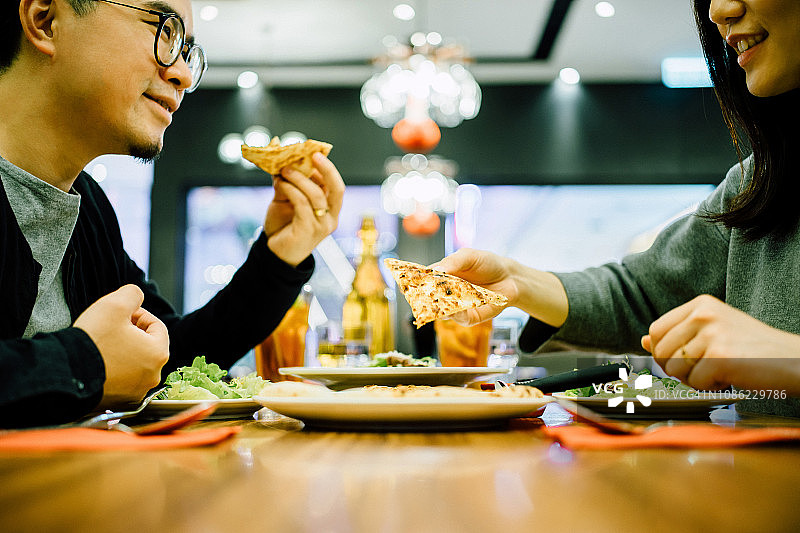 一对快乐的情侣在餐厅聊天，享受美食图片素材
