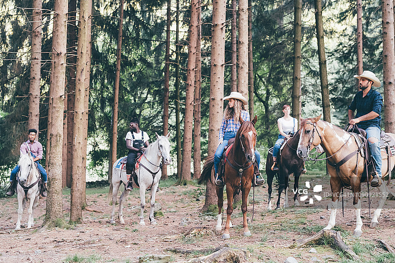 五个年轻人在森林里骑马，Primaluna，特伦蒂诺-上阿迪杰，意大利图片素材