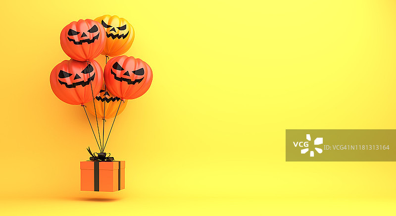 万圣节快乐设计创意概念庆祝节日，南瓜气球，礼盒上的橙色背景。图片素材