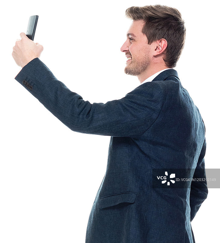 白人年轻男性摄影站着穿衬衫和使用智能手机图片素材