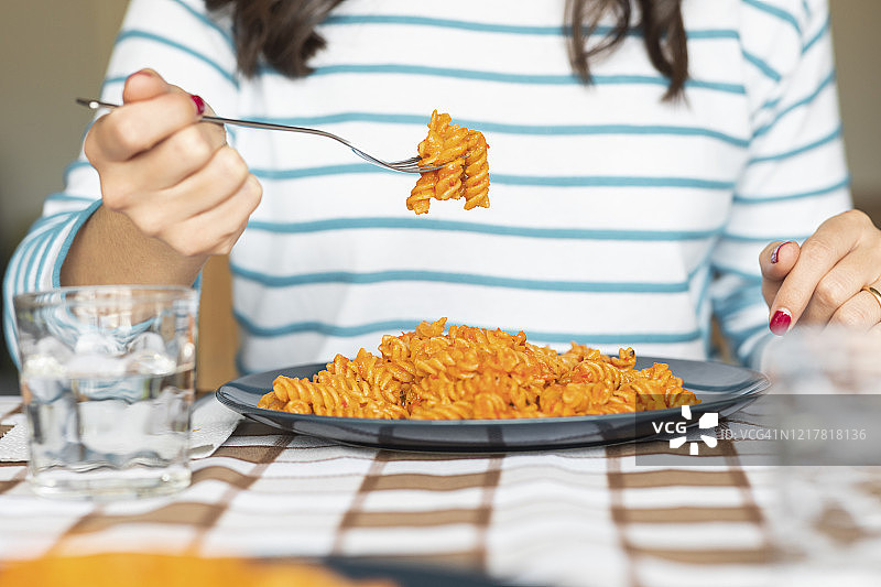 在家餐桌上吃意大利面的女人图片素材