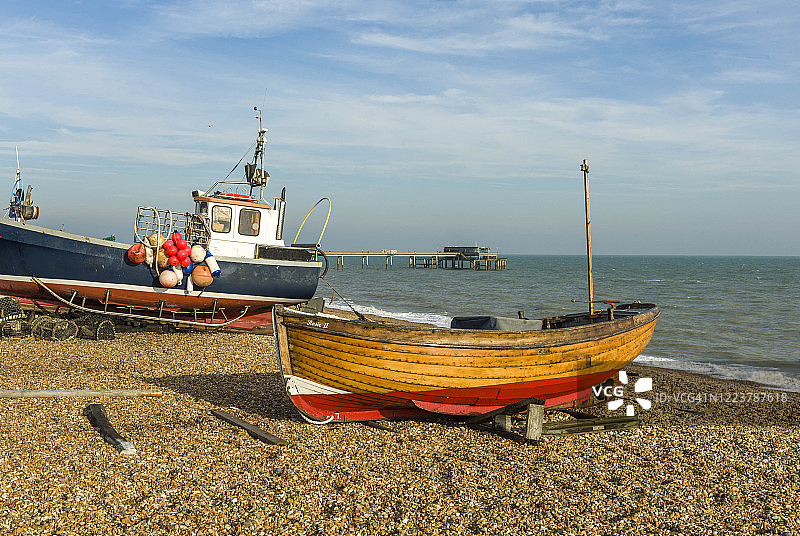 2014年11月28日，英国肯特。Deal海滩上的渔船以码头为背景。图片素材