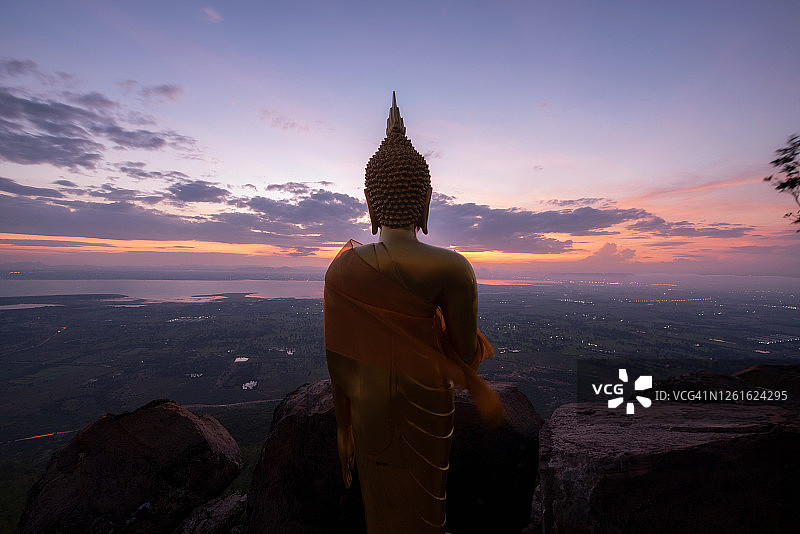 日出时分，泰国罗布里省Khao Prayadernthong寺的金佛雕像。图片素材