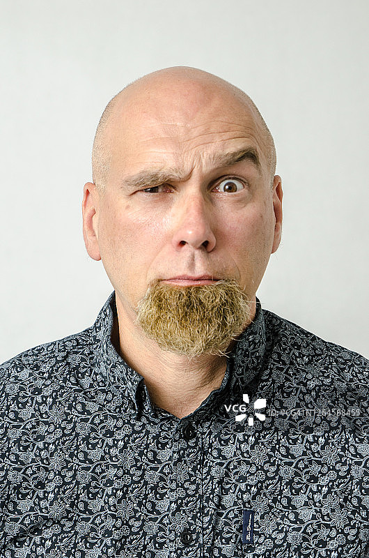 一个光头男人的肖像，下巴上染有棕色的胡须图片素材