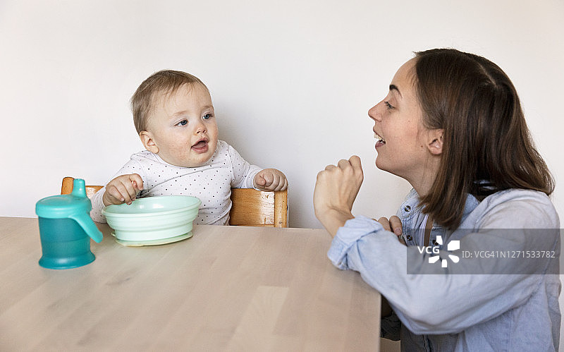 母亲和婴儿在餐桌上图片素材