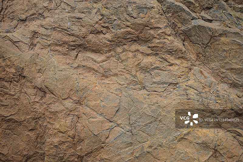 岩石纹理。石头的背景。浅棕色粗糙的背景。浅棕色灰色岩石纹理。图片素材