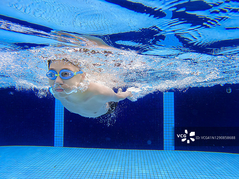 水下观亚洲华人少年在游泳池游泳图片素材