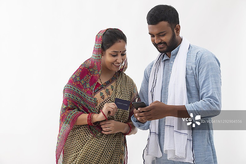 这是一对农村夫妻用信用卡进行在线交易的照片图片素材