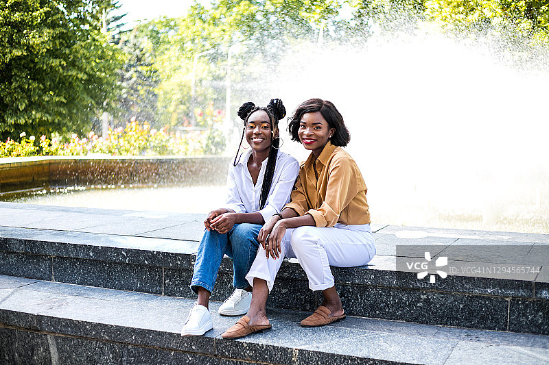两个美丽的黑人女孩一起在城市的街道上玩。图片素材