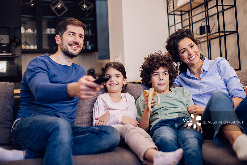 这是一个幸福的家庭在一起看电视节目，玩得很开心图片素材