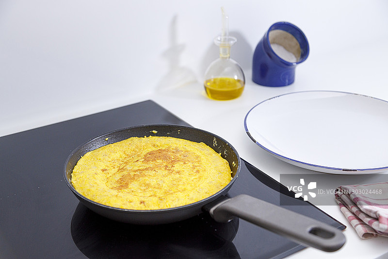 用平底锅煮鸡蛋和炸土豆的混合物，做成西班牙煎蛋卷图片素材