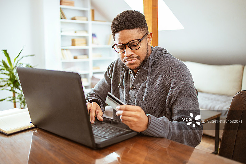年轻人用笔记本电脑和信用卡在网上购物图片素材