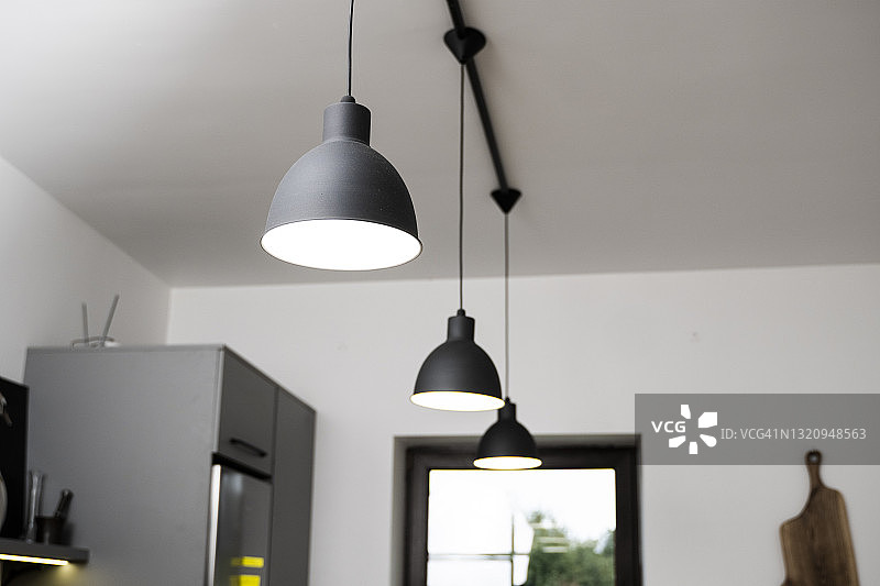 黑色工业吊灯在厨房内部。现代阁楼室内设计。图片素材