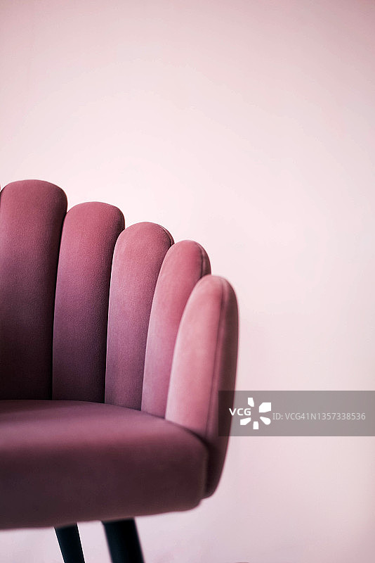 粉红色纹理天鹅绒扶手椅在粉红色的背景。图片素材