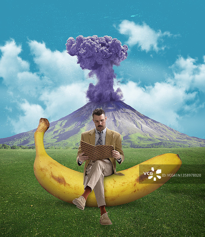 当代艺术拼贴画:一个人坐在香蕉上，孤立地坐在喷发的火山上阅读笔记本图片素材