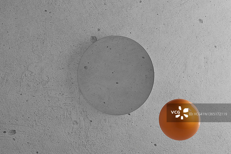 一个漂浮在混凝土墙前的橙色球体的数字图像。图片素材