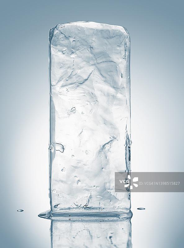 晶莹剔透的天然冰块在白色反射表面上以淡蓝色调。图片素材