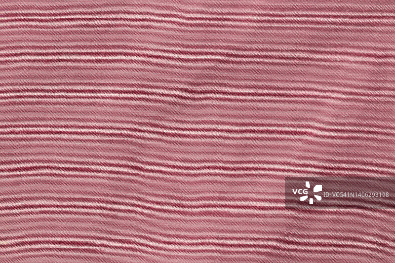 粉红色布布涤纶质感和织物背景。图片素材