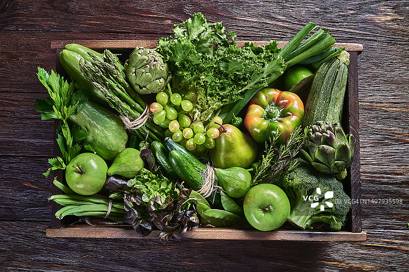 素食主题。表顶视图背景变异绿色蔬菜排毒和碱性饮食。放在板条箱里，放在有框架的木桌上图片素材