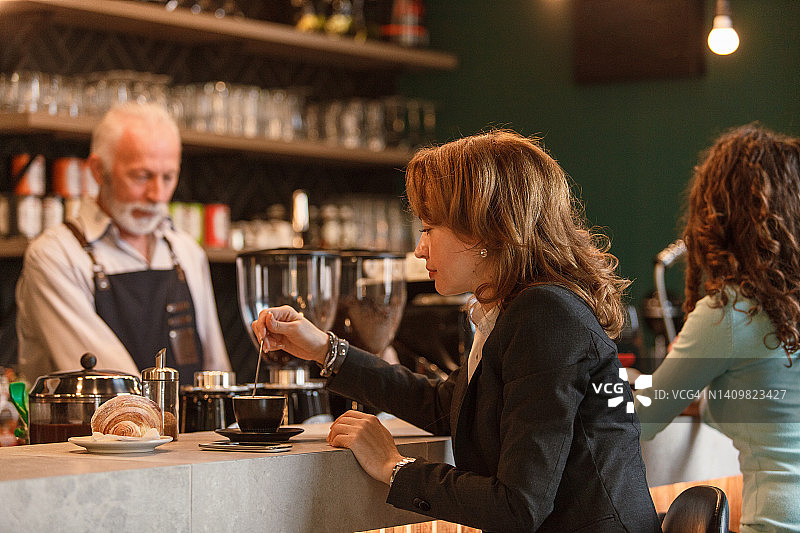 工作间隙，女商人在咖啡店享受一杯咖啡图片素材