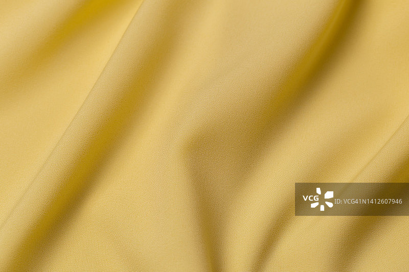 黄色布布涤纶质地和织物背景。图片素材
